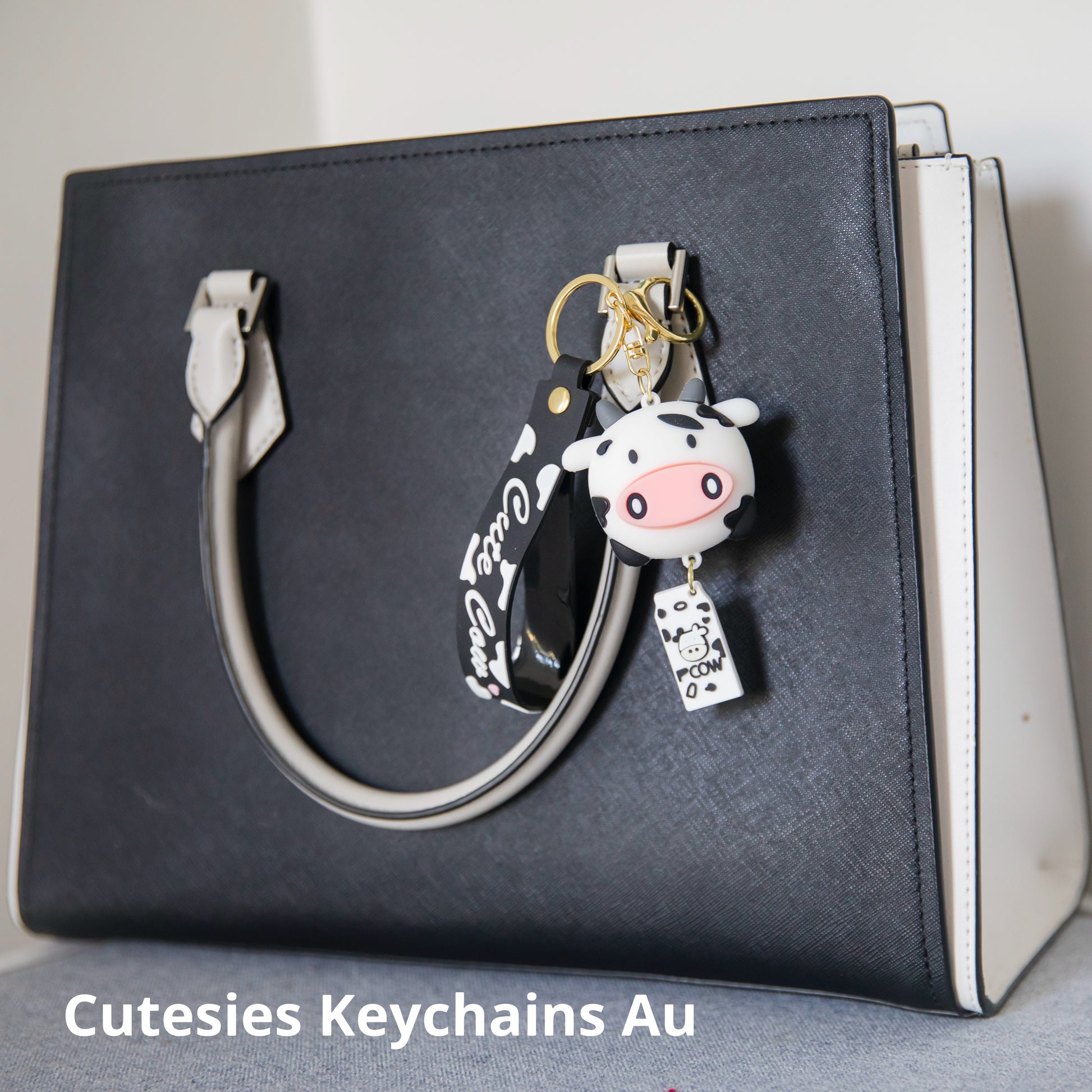 Cute black and white cow keychain with matching milk carton pendant and wristlet that says cute cow